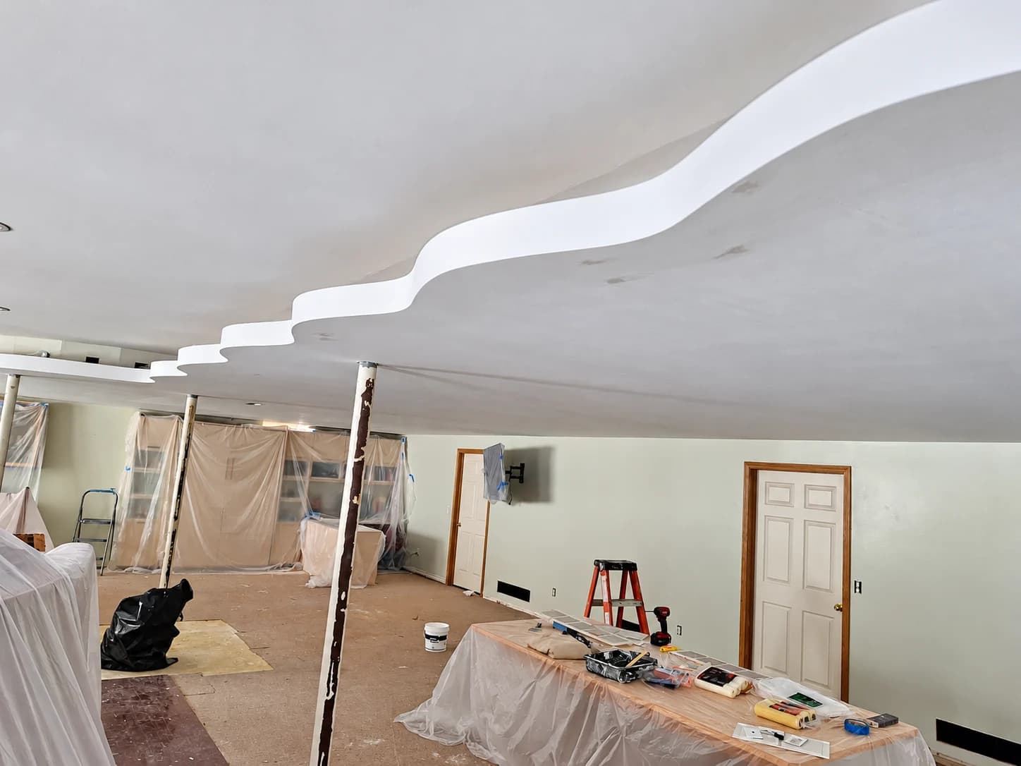 Curved sculpted ceiling detail in a residential interior under renovation